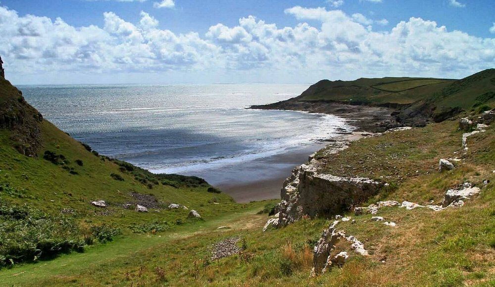 Stunning Gower coastline with green hills and beach