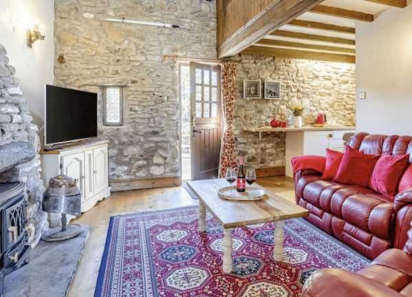King Arthur's Gallery - rustic living room with stone walls and exposed beams